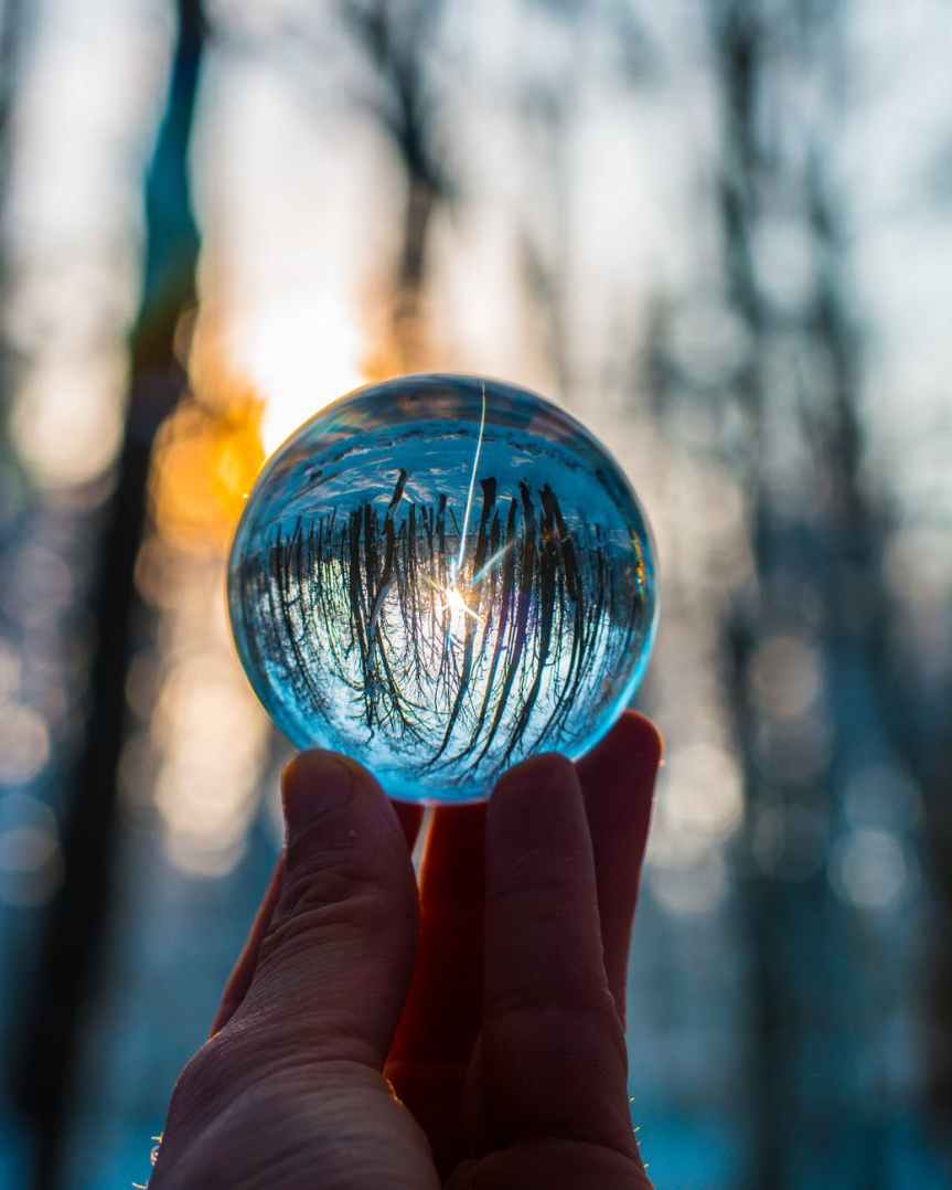 photo of person holding crystal ball